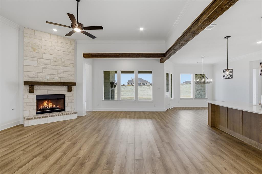 810 Vly Rdg Road Van Alstyne, TX 75495 - Photo 7 of 39 a view of empty room with wooden floor fireplace and windows
