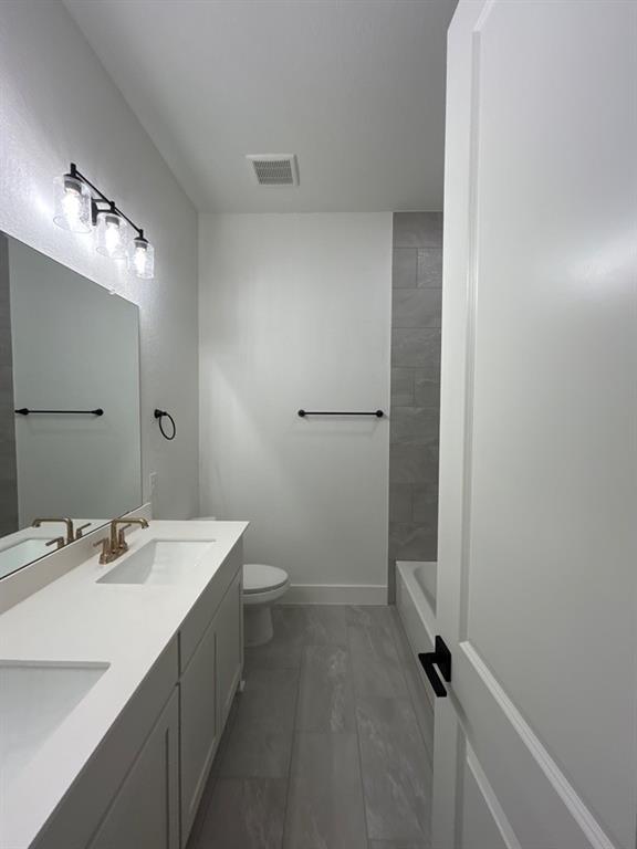 810 Vly Rdg Road Van Alstyne, TX 75495 - Photo 9 of 13 a bathroom with a sink a toilet and shower