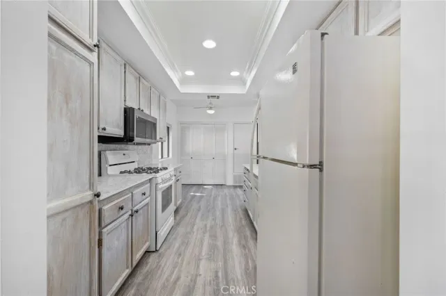 a kitchen with a sink stove and refrigerator