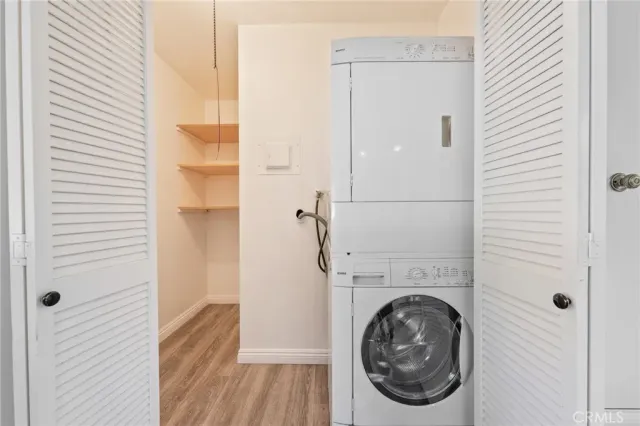 a kitchen with stainless steel appliances sink cabinets and wooden floor