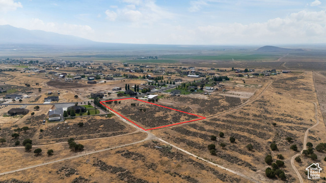 2974 West Ridgeline Road, Unit 85 Stockton, UT 84071 - Photo 7 of 23 Aerial view of sparsely populated area featuring a mountainous background and property boundaries highlighted