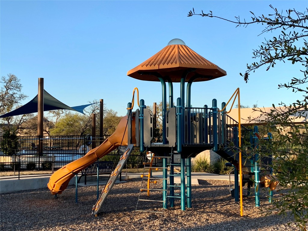 265 Falling Star Lane Georgetown, TX 78628 - Photo 17 of 22 a view of pool with two chairs and wooden fence