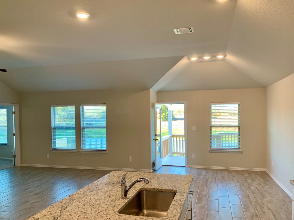 265 Falling Star Lane Georgetown, TX 78628 - Photo 7 of 22 wooden floor in an empty room with a window