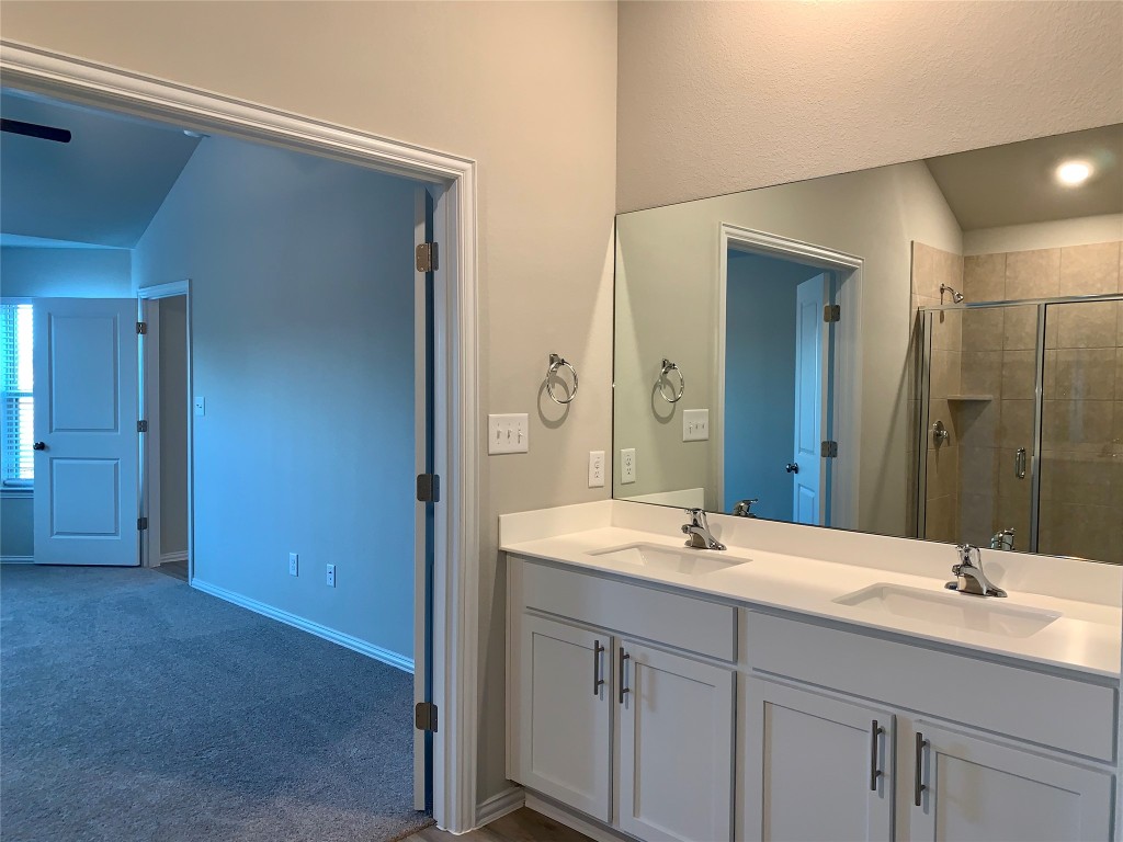 265 Falling Star Lane Georgetown, TX 78628 - Photo 8 of 22 a bathroom with double sink and a mirror