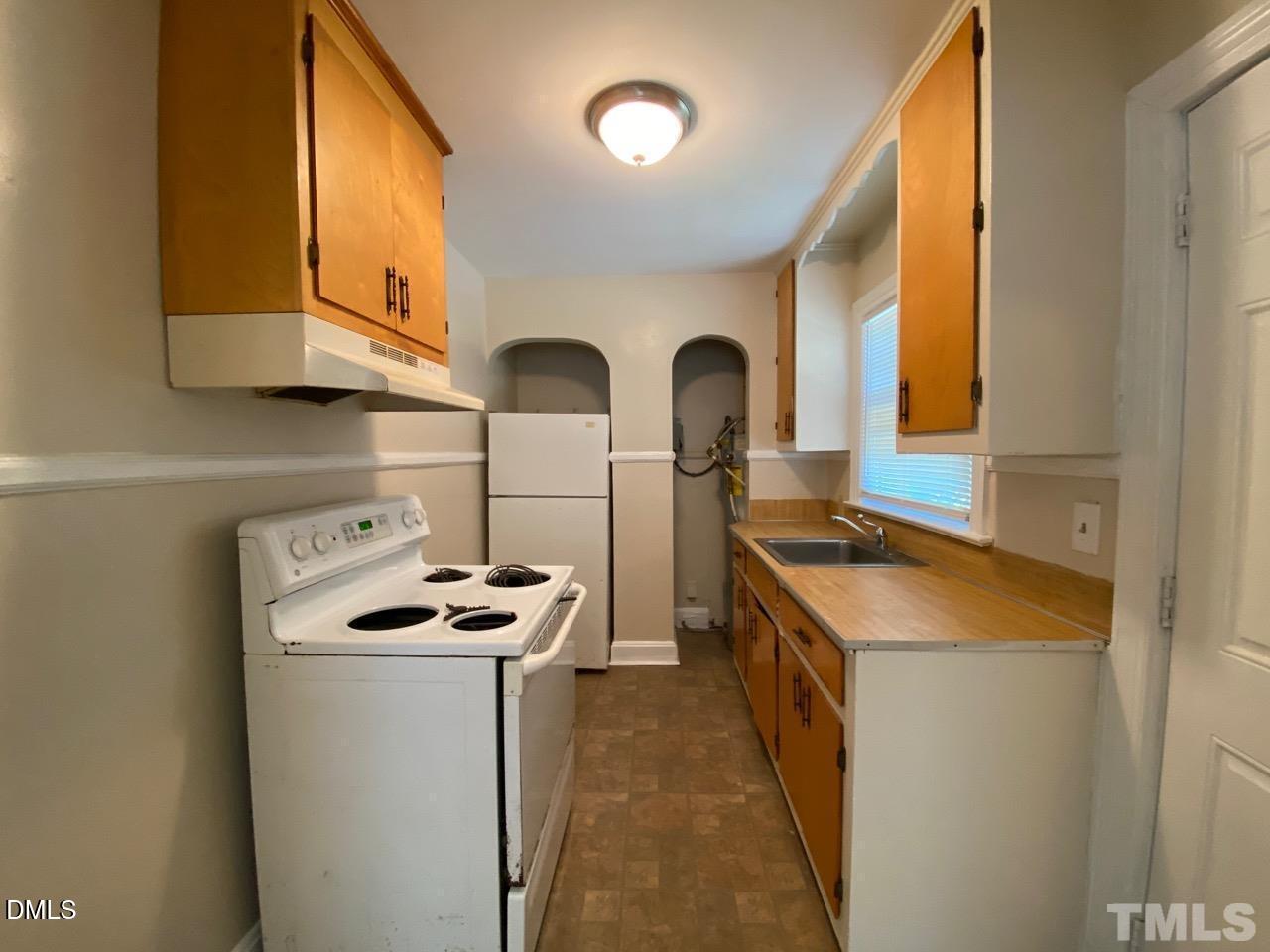 907 Bunn Terrace Durham, NC 27703 - Photo 2 of 8 a kitchen with stainless steel appliances granite countertop a stove and a sink