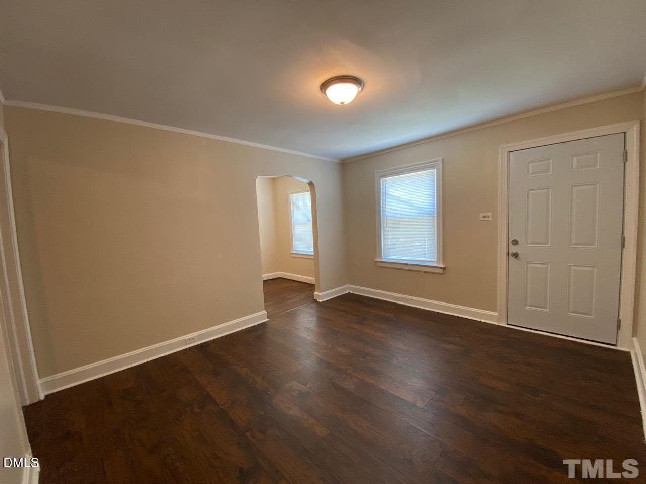 907 Bunn Terrace Durham, NC 27703 - Photo 5 of 8 an empty room with wooden floor and windows