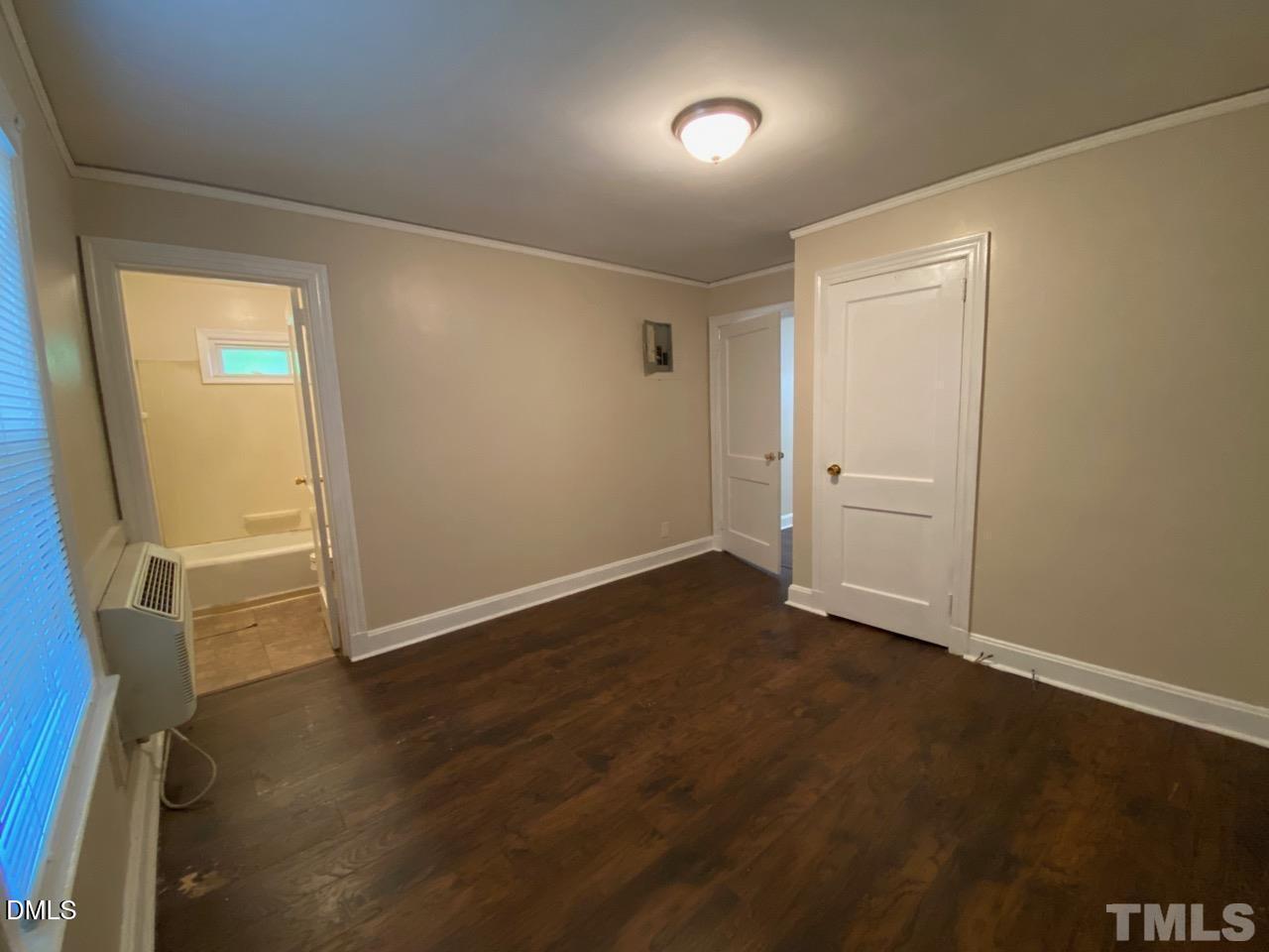 907 Bunn Terrace Durham, NC 27703 - Photo 7 of 8 an empty room with wooden floor and windows