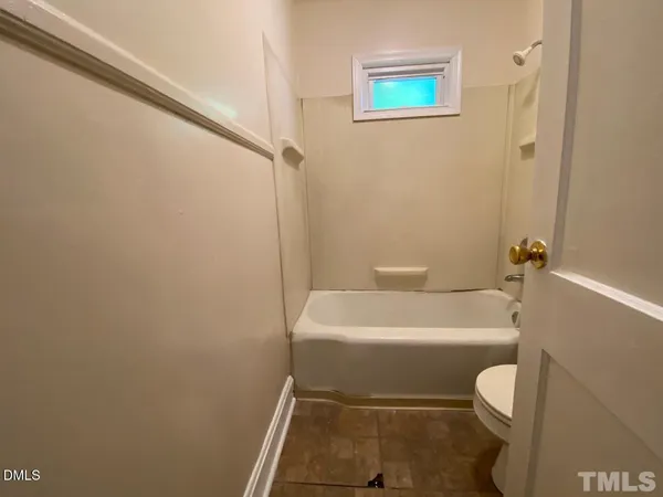 a white toilet sitting next to a white sink