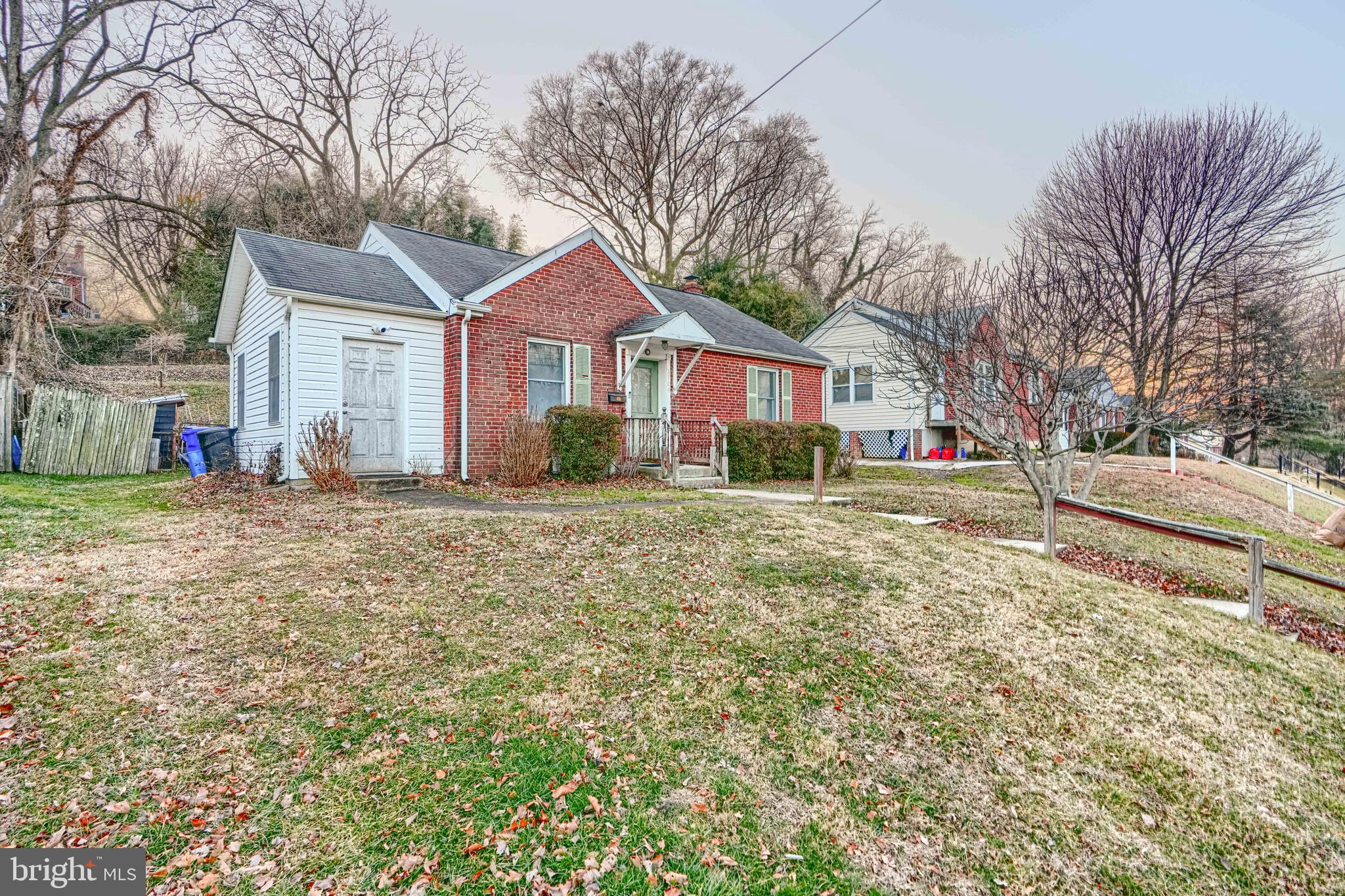 2704 Fenimore Road Silver Spring, MD 20902 - Photo 2 of 9 a front view of a house with a yard covered in snow