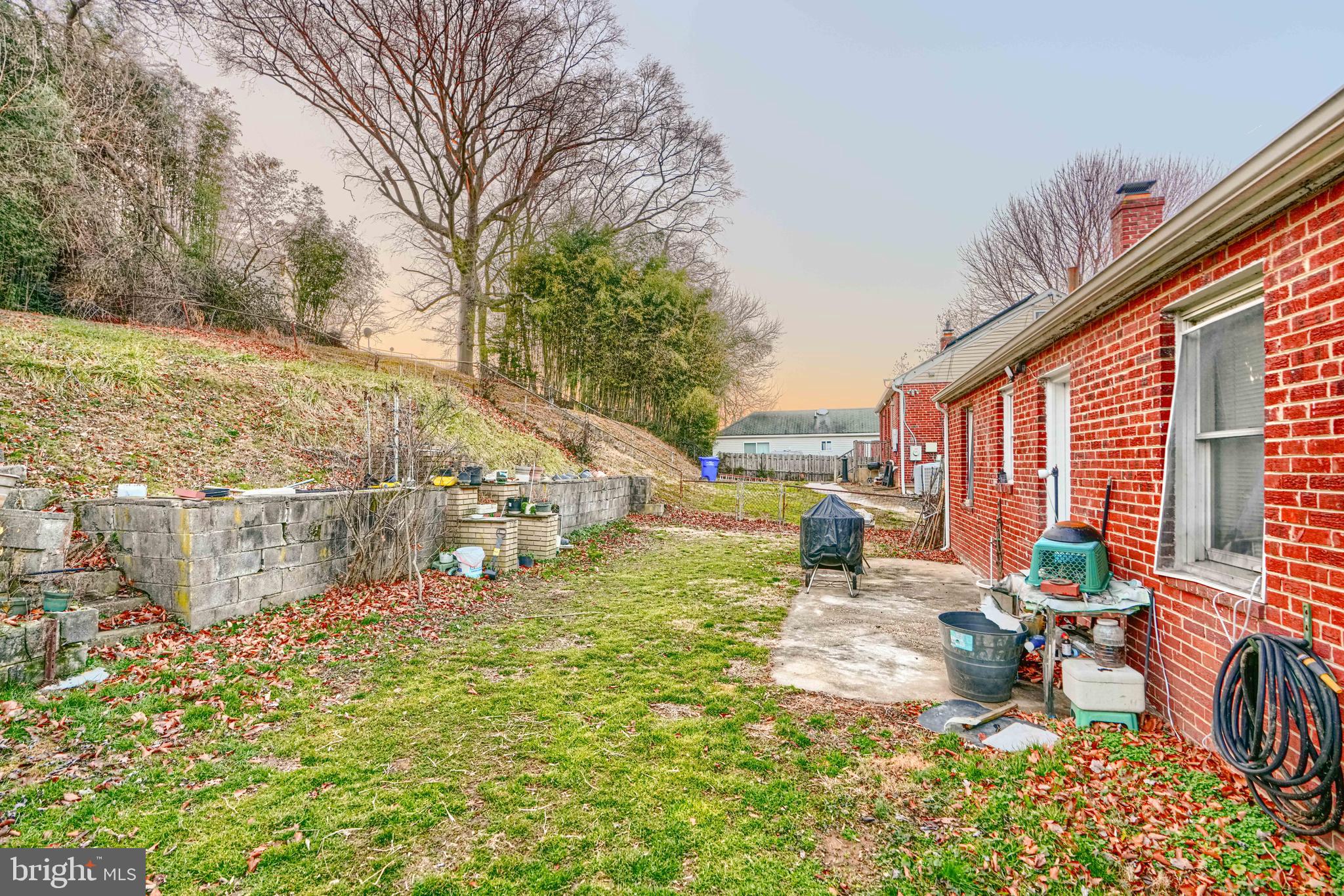 2704 Fenimore Road Silver Spring, MD 20902 - Photo 7 of 9 a view of a patio with table and chairs potted plants and large tree