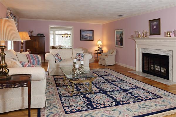 12 Falmouth Road Wellesley, MA 02481 - Photo 2 of 8 a living room with furniture and a fireplace