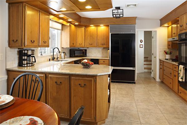 12 Falmouth Road Wellesley, MA 02481 - Photo 5 of 8 a kitchen with stainless steel appliances granite countertop a sink refrigerator and cabinets