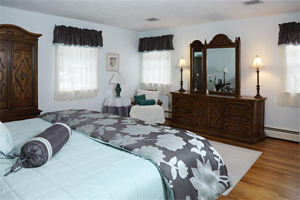 12 Falmouth Road Wellesley, MA 02481 - Photo 7 of 8 a bedroom with a bed a mirror and a window