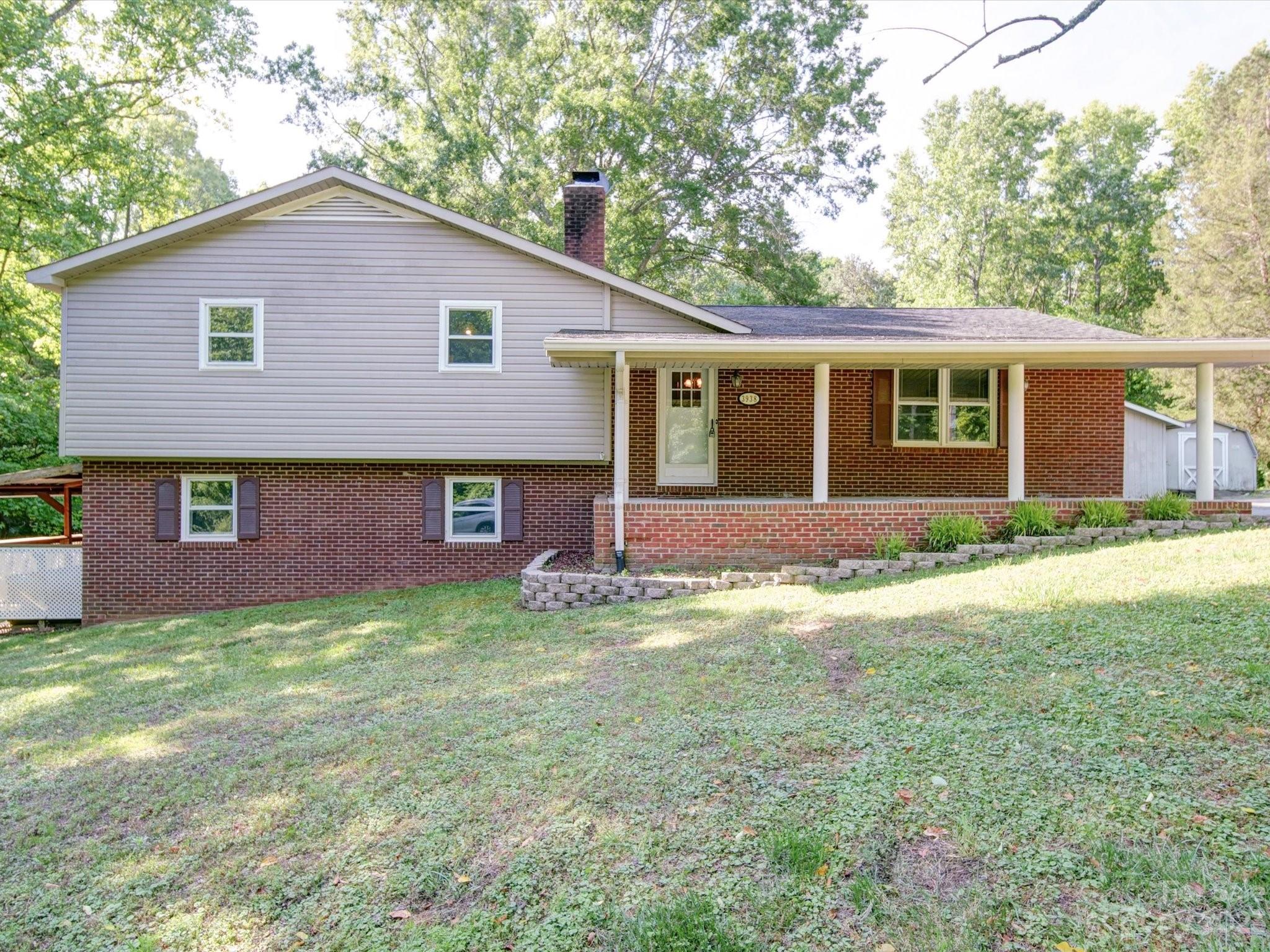 3938 Tater Ridge Road Concord, NC 28025 - Photo 1 of 23 a backyard of a house with yard and large tree