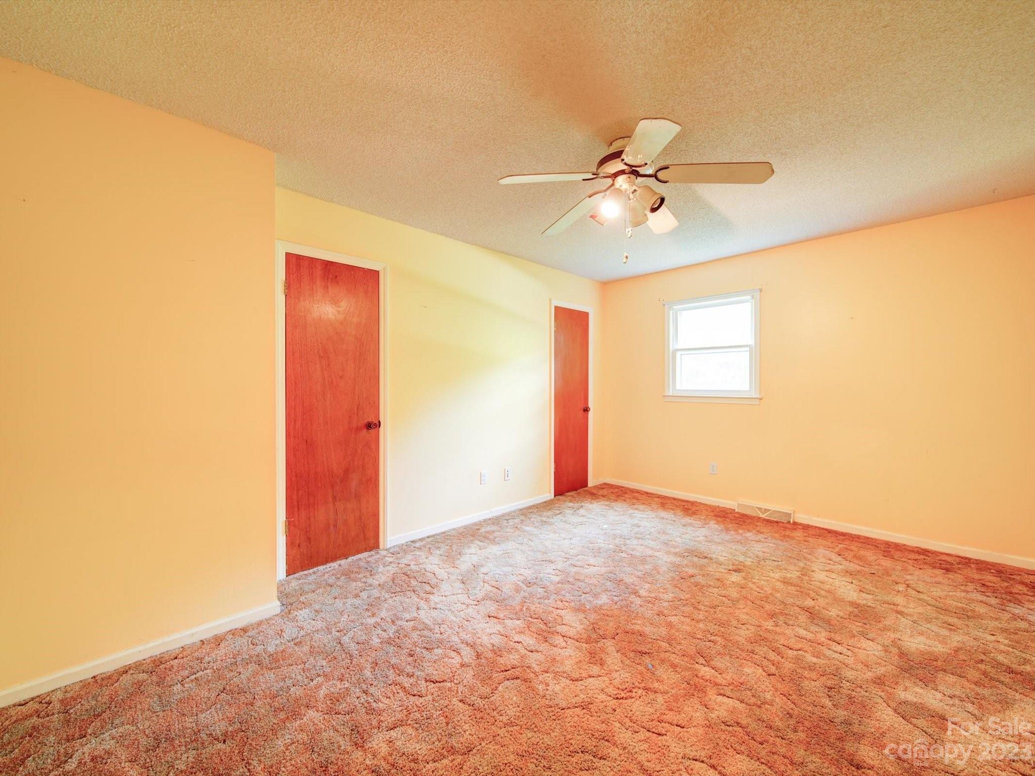 3938 Tater Ridge Road Concord, NC 28025 - Photo 7 of 23 an empty room with windows and fan