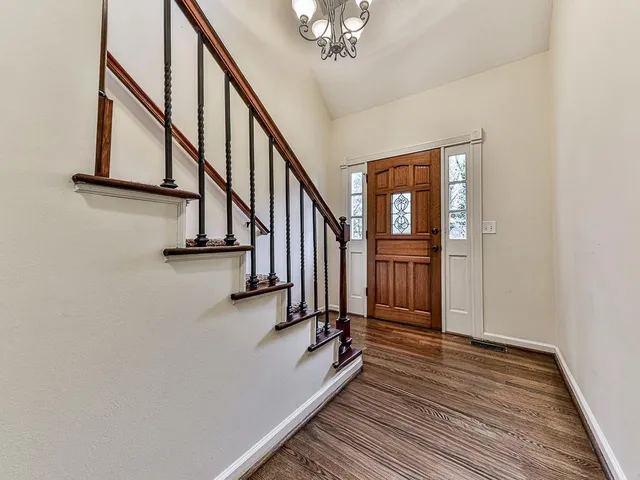 a view of entryway and hall with wooden floor