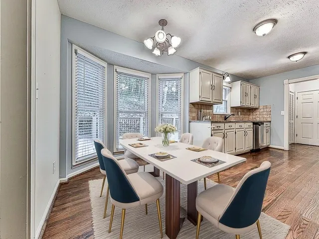 a view of a dining room with furniture window and wooden floor
