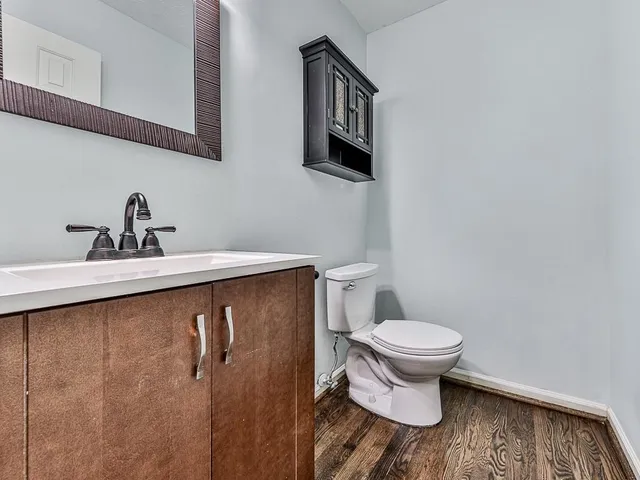 a bathroom with a sink toilet and a mirror
