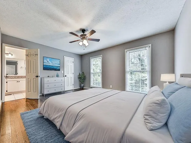 a spacious bedroom with a large bed and a window