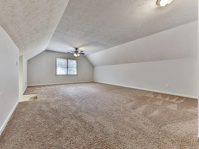 a view of a livingroom with a ceiling fan and window