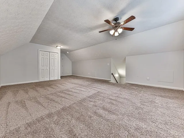 a view of a livingroom with a ceiling fan and window