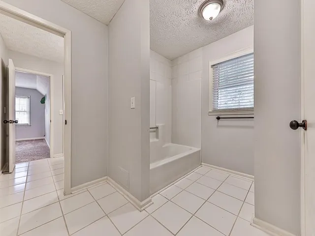 a spacious bathroom with a double vanity sink a mirror and a