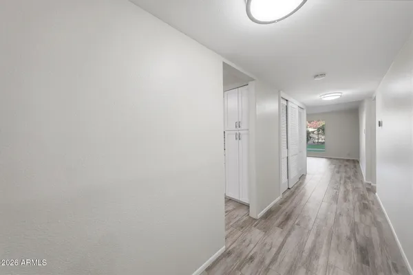 a view of an empty room with wooden floor