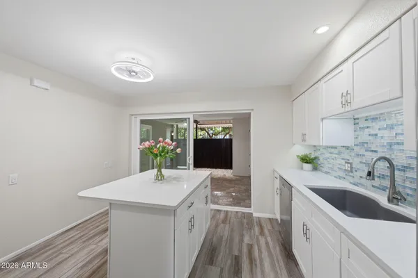 a view of a small space with a chandelier fan