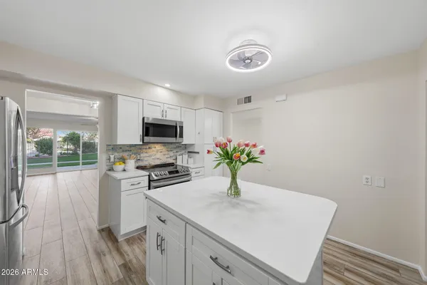 a bathroom with a sink vanity and a mirror
