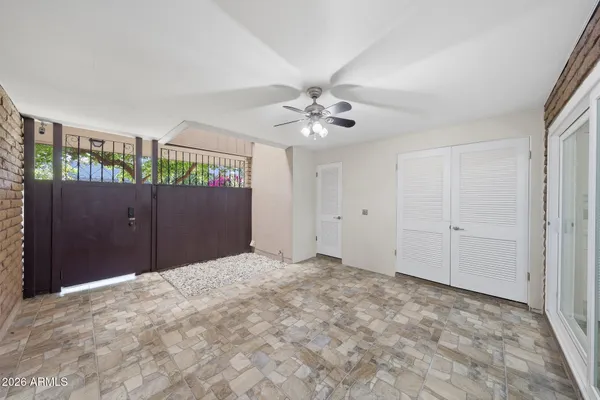 a view of livingroom with an empty space and a ceiling fan