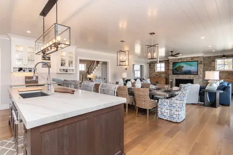a living room with lots of furniture and a wooden floor
