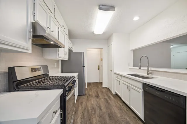 a kitchen that has a sink and a stove