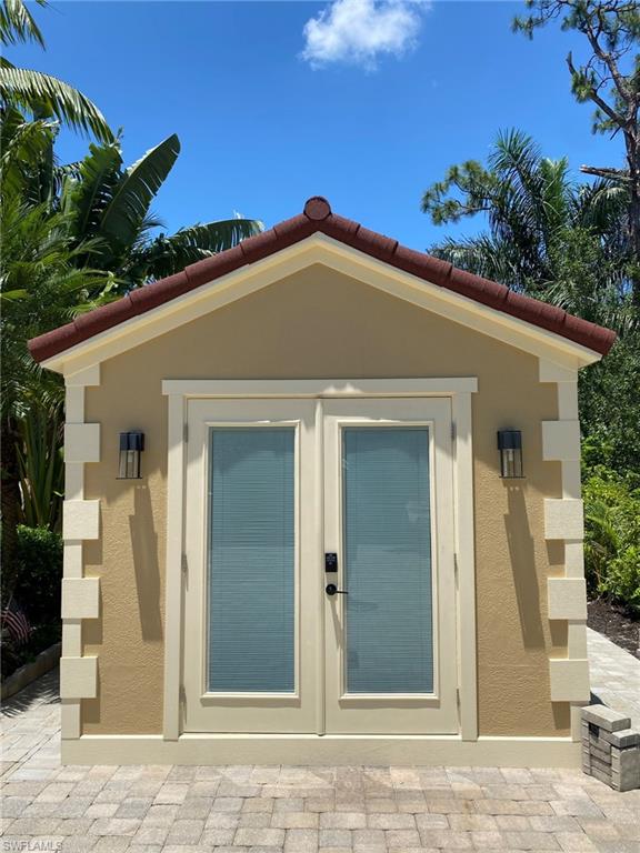 4948 Coach Lane Naples, FL 34114 - Photo 9 of 16 a front view of a house with a yard