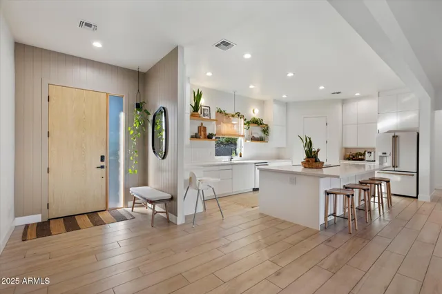 a kitchen with kitchen island stainless steel appliances a sink and cabinets
