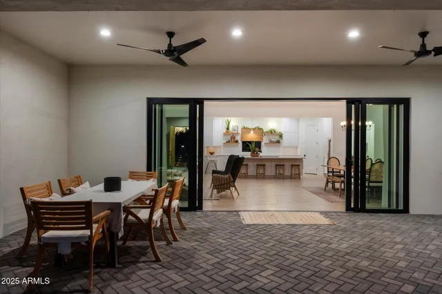 a view of a patio with table and chairs with wooden floor and fence