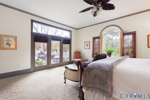 a living room with a bed furniture and a large window
