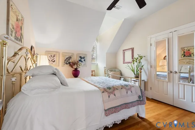 a bedroom with a large bed and a chandelier