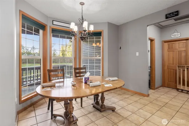 a living room with flat screen tv and refrigerator