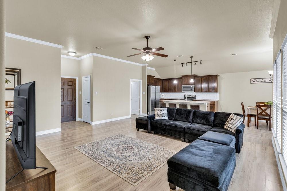118 Cherokee Street Greenville, TX 75402 - Photo 6 of 19 a living room with furniture and a view of kitchen