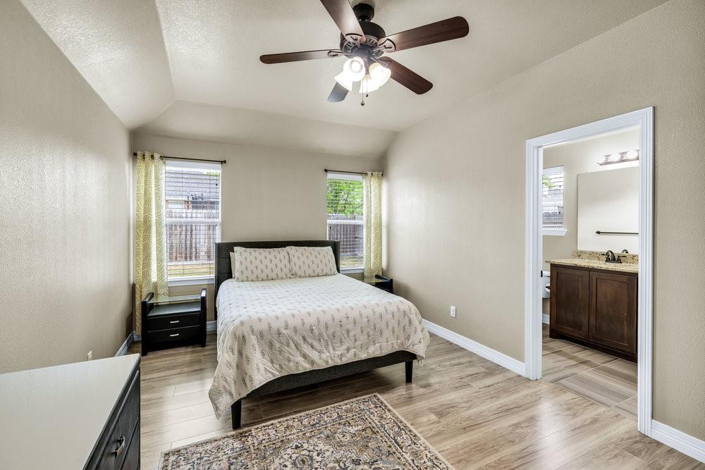 118 Cherokee Street Greenville, TX 75402 - Photo 8 of 19 a bedroom with a bed and a chandelier