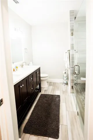 a dining room with furniture a large window and wooden floor