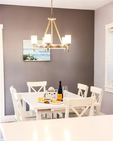a bathroom with a granite countertop sink a mirror and shower