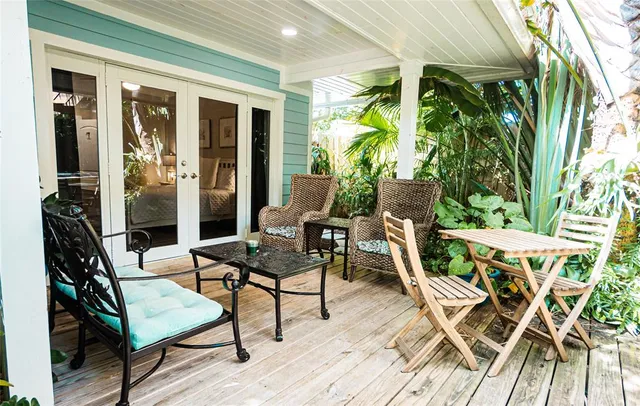 a backyard of a house with lots of green space and outdoor seating