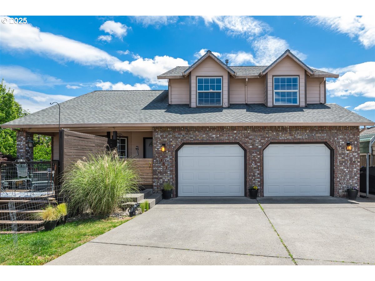 3253 Southeast 24th Terrace Gresham, OR 97080 - Photo 1 of 43 a front view of a house with a garden and plants