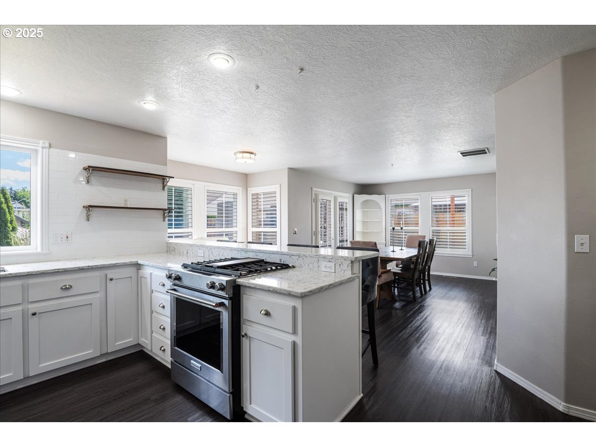 3253 Southeast 24th Terrace Gresham, OR 97080 - Photo 13 of 43 a kitchen with a stove a sink and a refrigerator