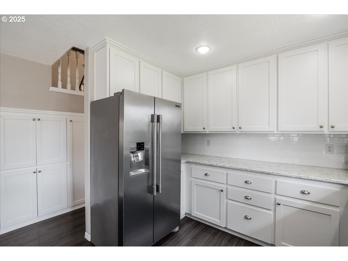 3253 Southeast 24th Terrace Gresham, OR 97080 - Photo 15 of 43 a kitchen with white cabinets and refrigerator