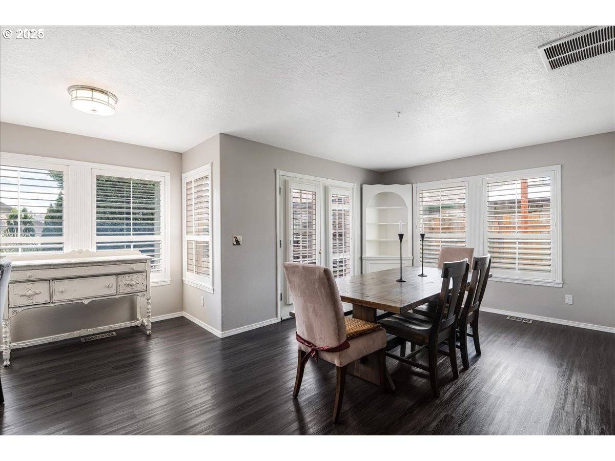 3253 Southeast 24th Terrace Gresham, OR 97080 - Photo 17 of 43 a view of a dining room with furniture and wooden floor