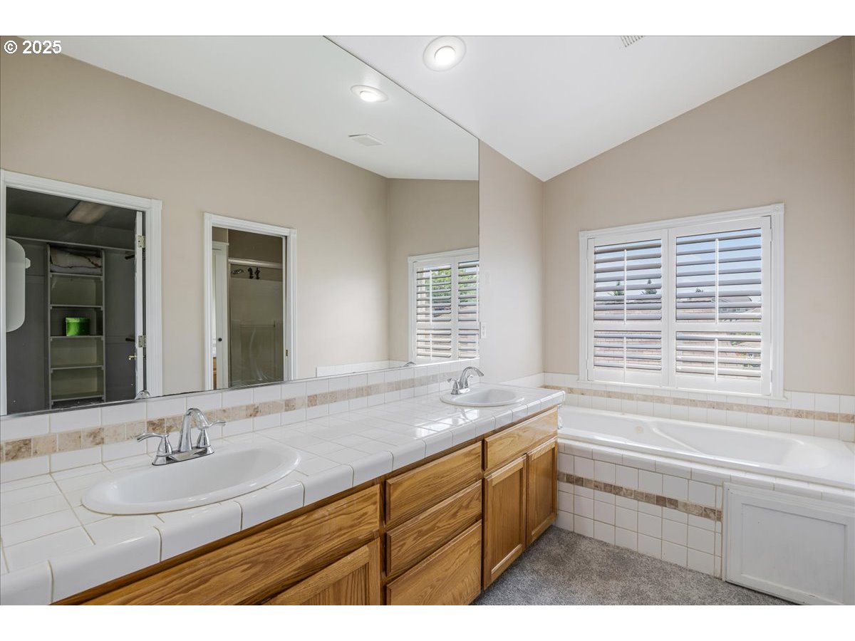 3253 Southeast 24th Terrace Gresham, OR 97080 - Photo 27 of 43 a bathroom with a sink double vanity granite tub and a mirror