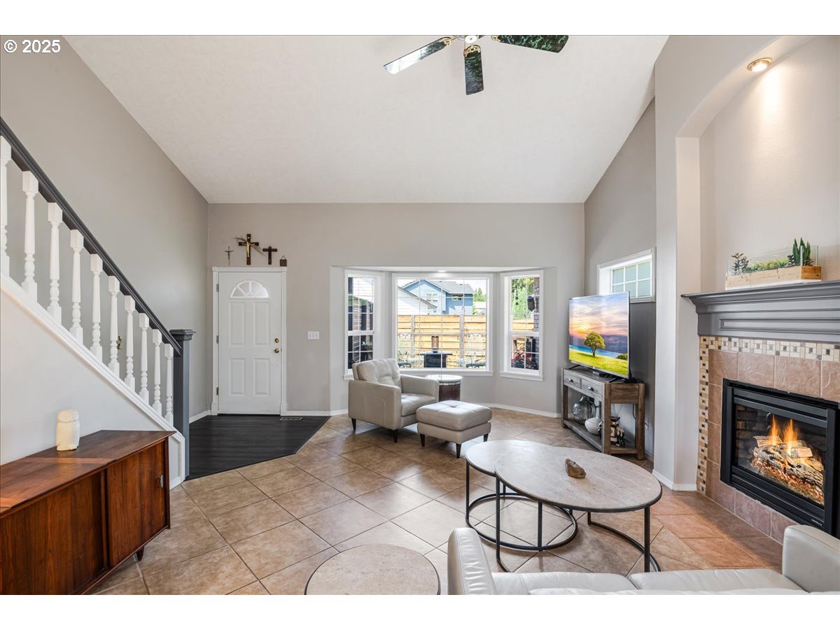 3253 Southeast 24th Terrace Gresham, OR 97080 - Photo 8 of 43 a living room with furniture a fireplace and a flat screen tv