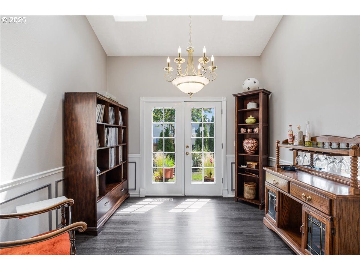 3253 Southeast 24th Terrace Gresham, OR 97080 - Photo 10 of 43 wooden floor in an empty room with a window and a kitchen